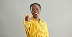 Face, happy black woman or pointing to you or volunteer offer isolated on grey background. Studio, winner or African person with gesture, choice or promotion showing an opportunity, vote or selection