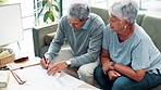 Senior couple, sofa and writing with documents for finance, budget planning or expenses at home. Elderly man and woman with financial paperwork for insurance, retirement plan or policy at the house