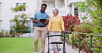 Caregiver, tablet and old woman with walker for homecare outdoor, walk for physical therapy and exercise. People in garden with digital schedule, patient with disability and nurse with rehabilitation