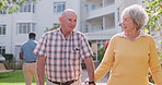 Senior couple, walker and outdoor in garden at hospital with conversation, holding hands and wave at carer. Elderly woman, old man and walking frame for person with disability in retirement at clinic