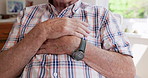 Closeup, home and old man with heart attack, hands and emergency with crisis and cardiac arrest. Apartment, pensioner and elderly person with stress and chest pain with breathing problem and anxiety