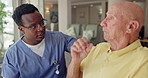 Elderly, home and nurse help man as caregiver in healthcare to offer support in retirement. Medical, service and volunteer in house with empathy for senior, care and speaking with kindness in nursing