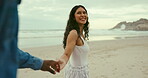 Beach, smile and interracial couple for romance, honeymoon and travel for trust, happy and walking. Woman, holding hands or sea on date to show partner adventure, happiness or conversation on holiday