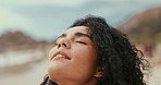 Calm, breathing and woman by beach for travel on vacation, adventure or holiday on island. Peace, relax and face of young female person with meditation by ocean on tropical island weekend trip.