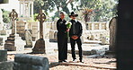 Flowers, senior or couple in graveyard for funeral, spiritual service or burial for respect in Christian religion. Support, depressed or sad people in cemetery for grief, loss or mourning a death