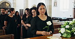 Coffin, funeral and woman with flower for death, mourning and people at burial ceremony in church. Memorial service, casket and sad person with rose for grief, respect or loss with farewell of family