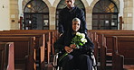 Senior woman, flowers and funeral service at church with wheelchair, sad man and burial ceremony. Family, grief or help person with a disability in chapel for memorial, death or mourning with bouquet