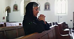 Sad, woman and praying in church with faith at funeral, service and memorial ceremony in religion for death. Mourning, widow and thinking of memory or respect prayer with worship in Christian chapel