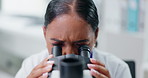 Woman, microscope and scientist with analysis of data, science experiment or medical research in laboratory. Assessment, test or review DNA sample with biotechnology or biology, innovation and future
