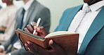 Businessman, hands and writing with book in row for notes, presentation or waiting room at the office. Closeup of man or employee filling notebook in line for schedule or attention at the workplace