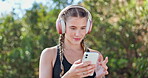 Woman, headphones and phone for music, runner and streaming radio for fitness workout in nature. Female person, cardio and app or website for playlist, audio subscription and training for marathon