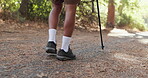 Legs, hiking stick and trekking in forest for adventure in nature for walking journey, explore or countryside. Person, boots and mountain path for environment workout in Australia, travel or trees