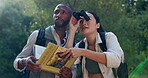 Outdoor, forest and adventure for couple with binoculars and   book for birdwatching in woods for journey. Location, man and woman in relationship on date for travel in nature with technology