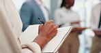 Person, hands and writing with book in meeting for schedule planning, reminder or business at office. Closeup of employee taking notes in notebook for ideas, plan or report in discussion at workplace