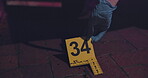 Evidence marker, hand of csi and crime scene with forensic on floor at night for investigation of murder. Professional, expert in gloves and case investigator with observation and search with blood