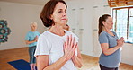 Senior woman, yoga and meditation with hands together for zen, spiritual wellness or balance together. Elderly people, yogi or group in exercise, pilates or fitness for warm up, awareness or health