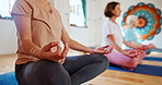 Woman, hands and meditation with yoga class for spiritual wellness, breathing or inner peace. Closeup of female person or yogi meditating in lotus for health. awareness or chakra together on mat