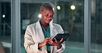 Tablet, smile and black female doctor in hospital , healthcare or medical research on touchscreen. Dark, night and technology for wellness professional, clinic and medicine worker for woman person