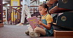 Reading book, learning or girl in a library for a story in school campus for education on bookshelf. Floor, kid or smart child student with scholarship studying knowledge, research or information