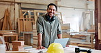 Laptop, carpenter and face of man in workshop for maintenance, remodeling and construction. Manufacturing, furniture factory and portrait of person on computer for website, internet and online order