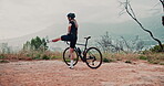 Woman, stretching legs and bike for cycling with fitness outdoor, rider ready for race and workout in park. Kick, training and warm up with bicycle in nature, cyclist start exercise and sports