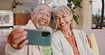 Happy couple, selfie or video call with smartphone in living room with affection, smile and bonding together. Marriage, romance and relationship of elderly people, old man and woman on sofa at home