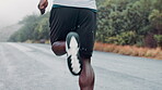 Man, running and mountain road for exercise workout in raining weather for commitment, routine or discipline. Male person, back and fitness shoes as healthy athlete for marathon, training or outdoor