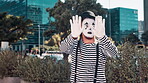 Mime, artist and man in city with paint on face for performance, action and comedy outdoor. Art, creativity and comic acting in urban street for drama or show, entertainment and mask for fun