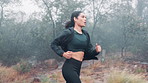 Woman, running and fitness outdoor with breathing for wellness, cardio and endurance with focus in nature. Exercise, sports and training for race with health, runner or athlete for workout in park