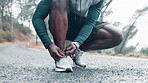 Athlete, hands and shoelace for male runner, nature and outdoor for workout on road in morning. Fitness, mist and marathon training for wellness and cardio exercise, shoes and footwear for sports