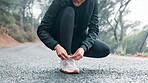 Athlete, hands and shoelace for female runner, nature and outdoor for workout on road in morning. Fitness, mist and marathon training for wellness and cardio exercise, shoes and footwear for sports