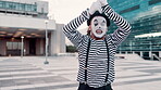 Mime, art and man outdoor with paint on face for performance, action and comedy in city. Artist, creativity and comic acting in urban street, climb imaginary rope and entertainment with mask for fun