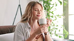 Woman, smile and calm with coffee, relax and rest at home or apartment living room. Lady, window and peace for cappuccino, espresso and break for breakfast for happiness on sofa in lounge or house