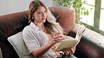 Woman, reading book and couch relax in home for holiday weekend or literature, knowledge or education. Female person, sofa and apartment living room or comfort for peace day off, hobby or fiction
