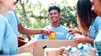 Happy people, box and food with donations for charity, NGO or community together in nature. Group of volunteers with smile for parcel, package or packing natural resources in teamwork at outdoor park