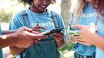 Park, volunteer and smartphone in group with smile for social media, teamwork or charity website. Friends, happy and typing on technology for online update, notification or communication on earth day