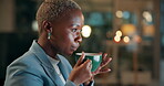 Business woman, night in office with coffee, blowing and relax by reading email for online project. African person, drinking and espresso cup by pc at desk, journalist and caffeine at work for energy