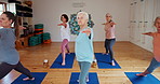 Senior woman, yoga and class with instructor for zen, spiritual wellness or balance together. Elderly people, yogi or group in coaching, warrior pose or fitness for exercise, pilates or awareness