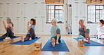 Exercise, yoga and senior women in class for wellness, healthy body and stretching on floor. Retirement, pilates club and elderly people on sports mat for fitness, workout and training together
