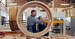 Workshop, carpenter and manager with woman, wood and working on frame of shape in startup. Business, entrepreneur and mature man with intern in garage, professional and manufacturing for project
