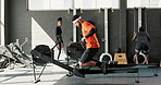 Rower, man and wellness in a gym, exercise and training with endurance and challenge with hobby. People, group and athlete with progress and rowing in a health center, active and workout with fitness