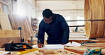 Black man, carpenter and drawing at workshop for furniture and design. Handyman, carpentry and tools for repair on startup business for training on woodwork at warehouse, factory and sketching
