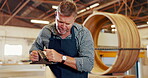 Mature man, carpenter and wood at workshop with filling or puttying for furniture and design. Carpentry, tools and repair on startup business as manager or supervisor in warehouse or factory. 
