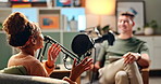 Happy people interview and laughing with podcast in meeting for discussion, conversation or news at studio. Young man and woman on air or talk show with mic for communication, live chat or recording