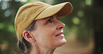 Hiking, face or mature woman thinking in woods or nature for peace, trekking or outdoor adventure. Smile, relax or hiker walking in park, forest or Norway for exercise or wellness on holiday vacation