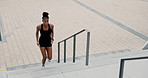 Stairs, running and black woman with exercise, city and endurance with challenge and progress. Fitness, African person and steps with athlete, training or runner with breathing or cardio with workout