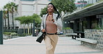 Business woman, running and late in city with briefcase for corporate job with speed on urban sidewalk. African employee, person and worker with bag, rush or schedule for fast commute on metro street