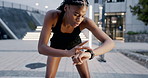 Fitness, running and black woman checking watch for for workout schedule, training and breathing in city. Urban exercise, time and girl runner in street to relax with smart app tracker on stopwatch