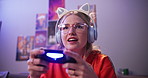 Headphones, woman and playing video game in home for competition, rpg and tournament online. Controller, girl and person on console technology for entertainment with neon light in apartment at night