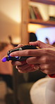 Woman, gaming and closeup of hand with controller for video game, competition and challenge. Home, digital technology and gamer with joystick for streaming, online contest and action in living room
